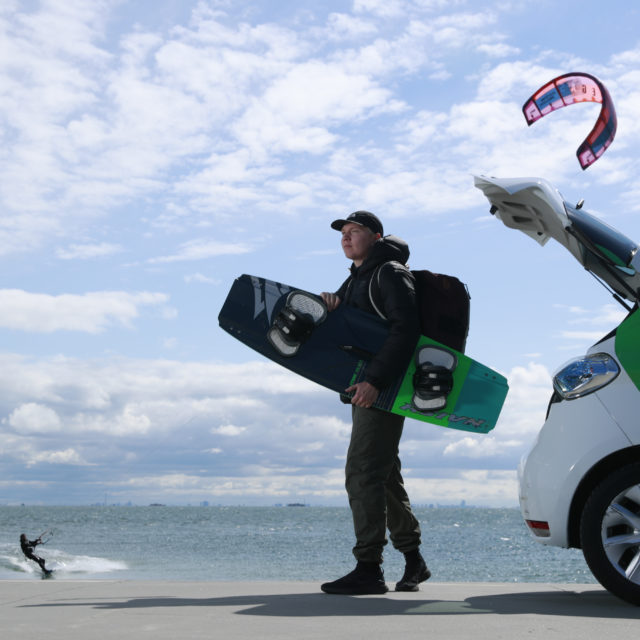 Man with snowboard and a Green