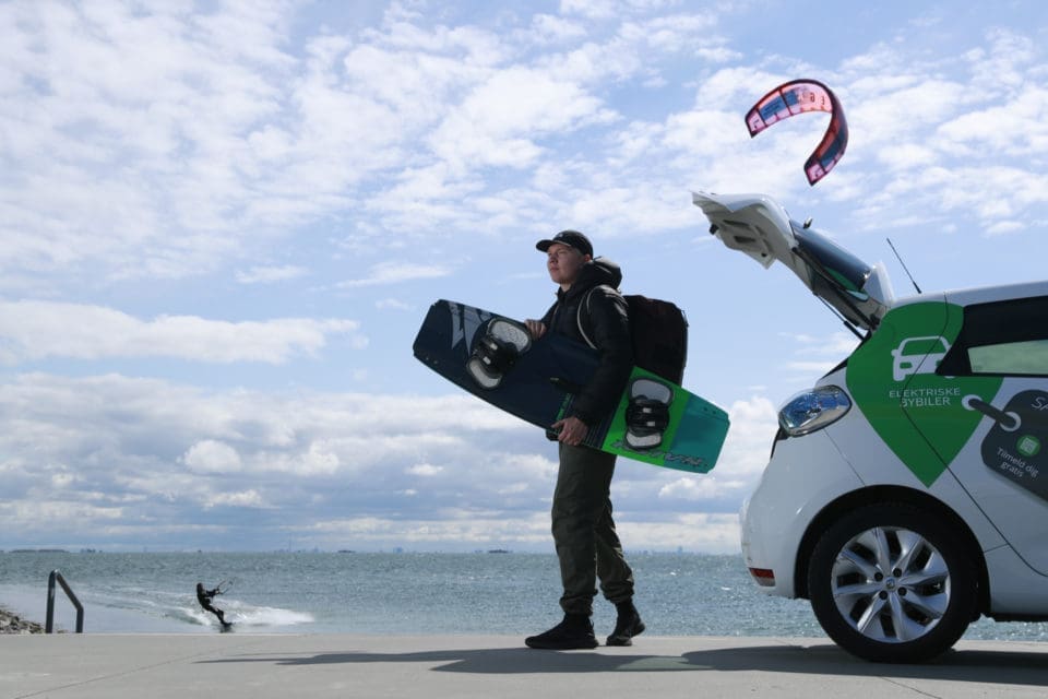 Man with snowboard and a Green