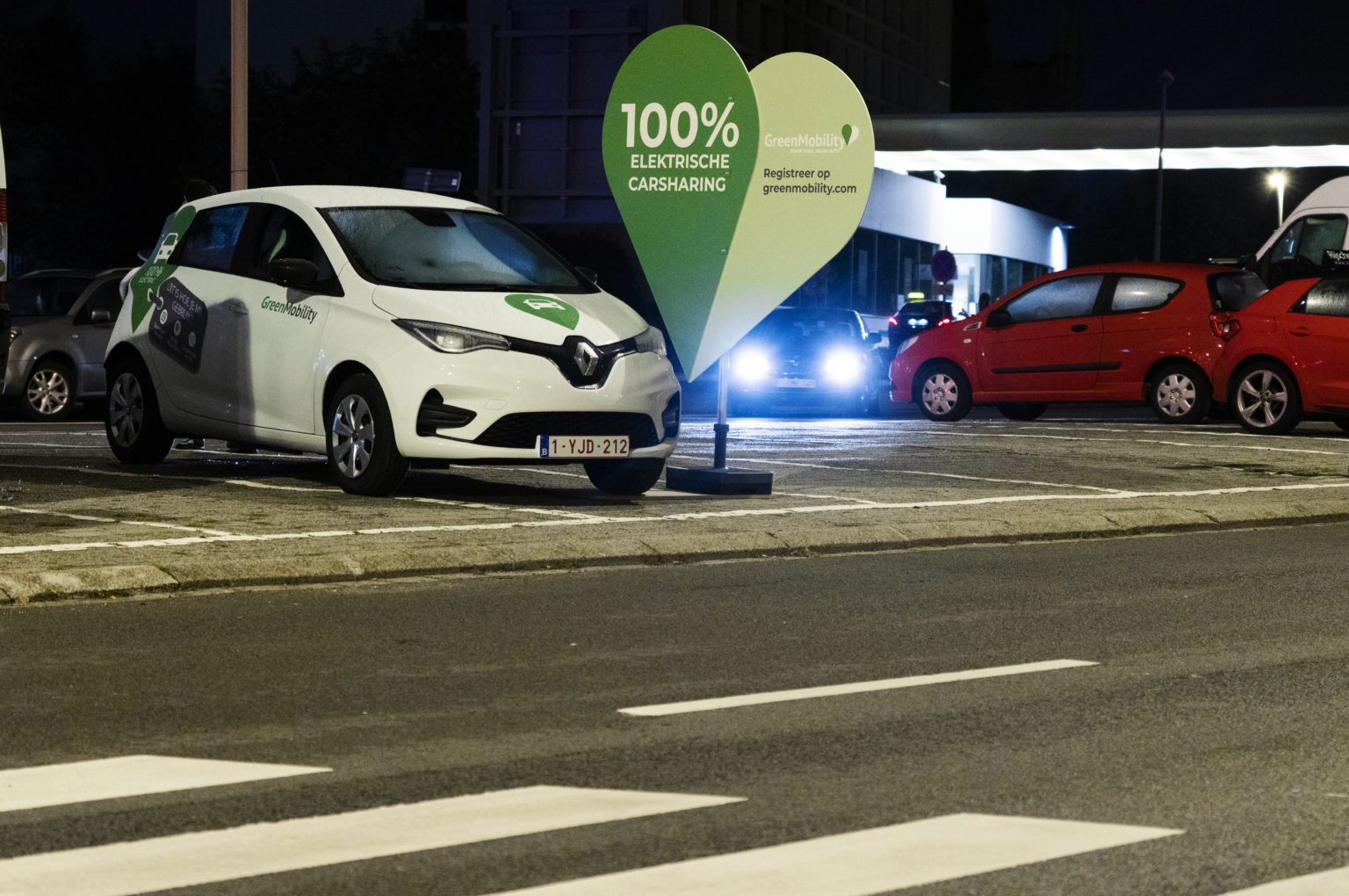 GreenMobility car at night with a big green heart