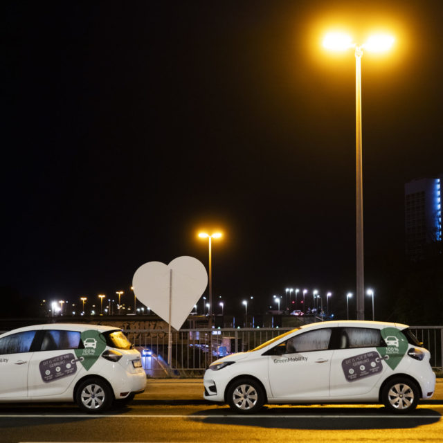 GreenMobility cars in a row at night