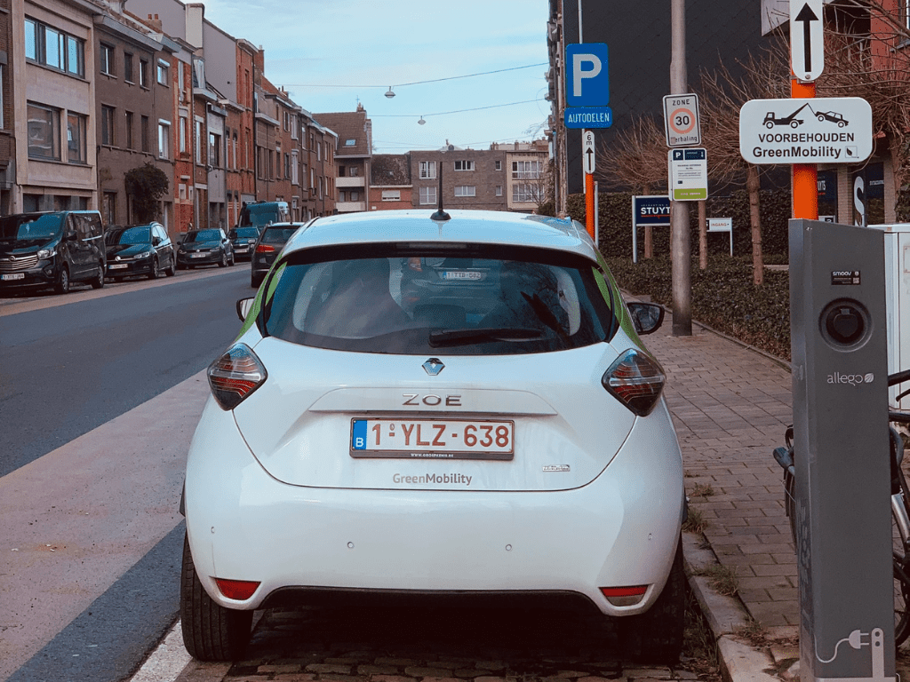 Green car on a GreenMobility Hotspot with charging