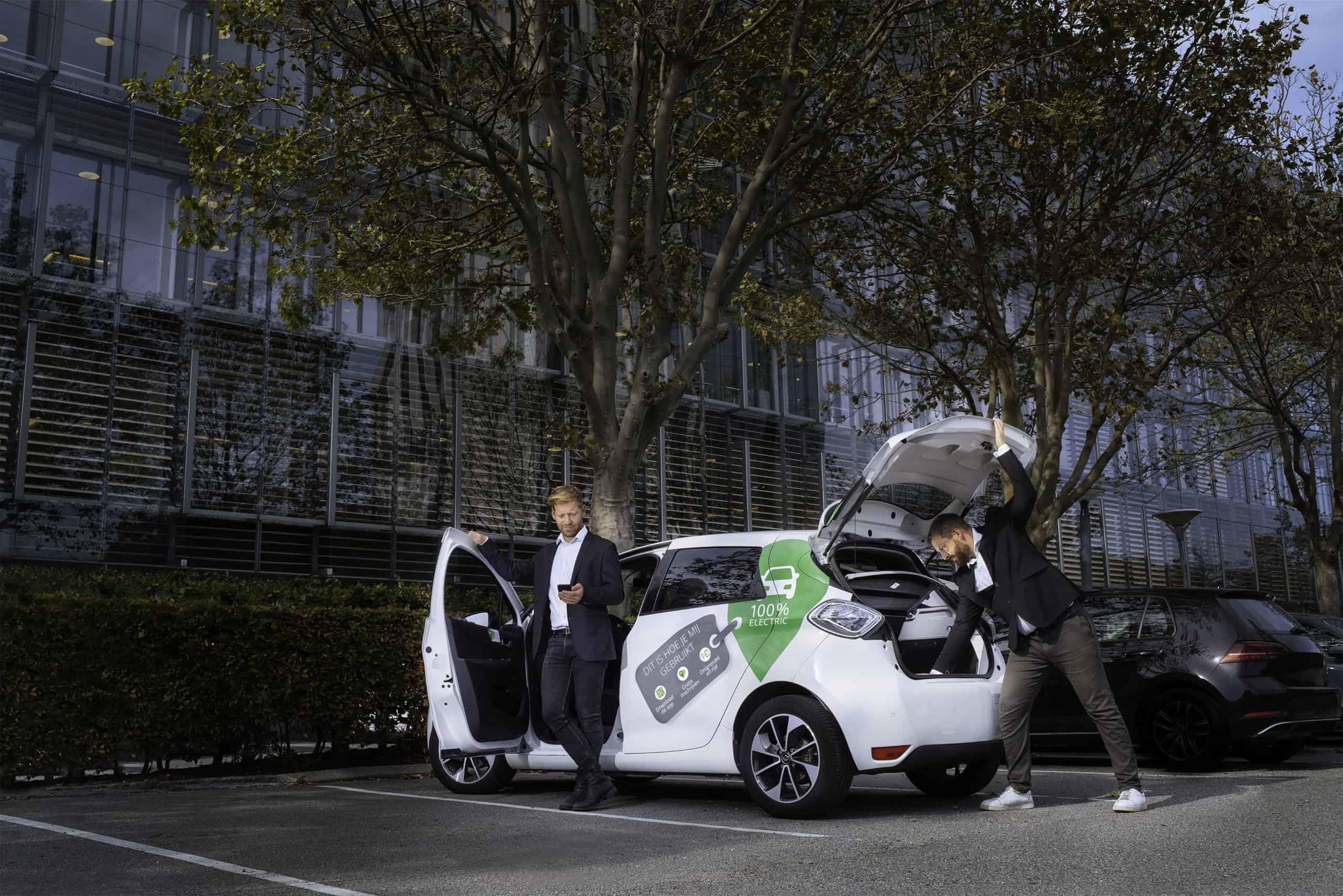 Two business men get our of electric car